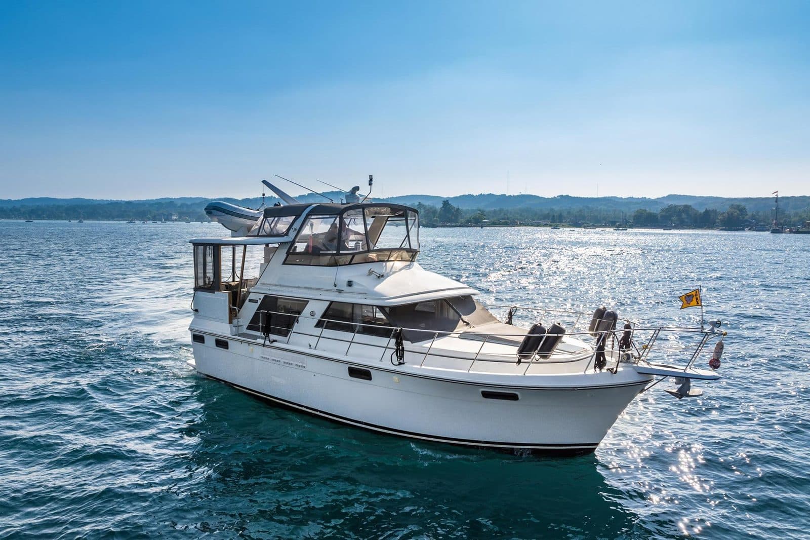 Motor yacht cruising at sunset